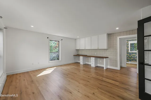 a view of a room with wooden floor and a window
