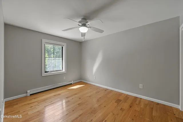 a view of a house with a yard and potted plants