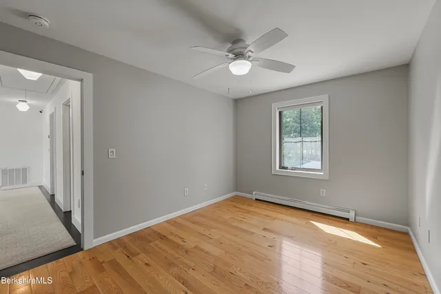 a view of backyard with swimming pool and seating