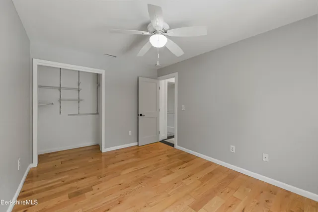 a view of a deck with a chair and floor to ceiling window