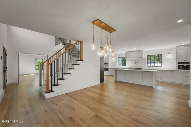 a kitchen with stainless steel appliances granite countertop a sink and a stove