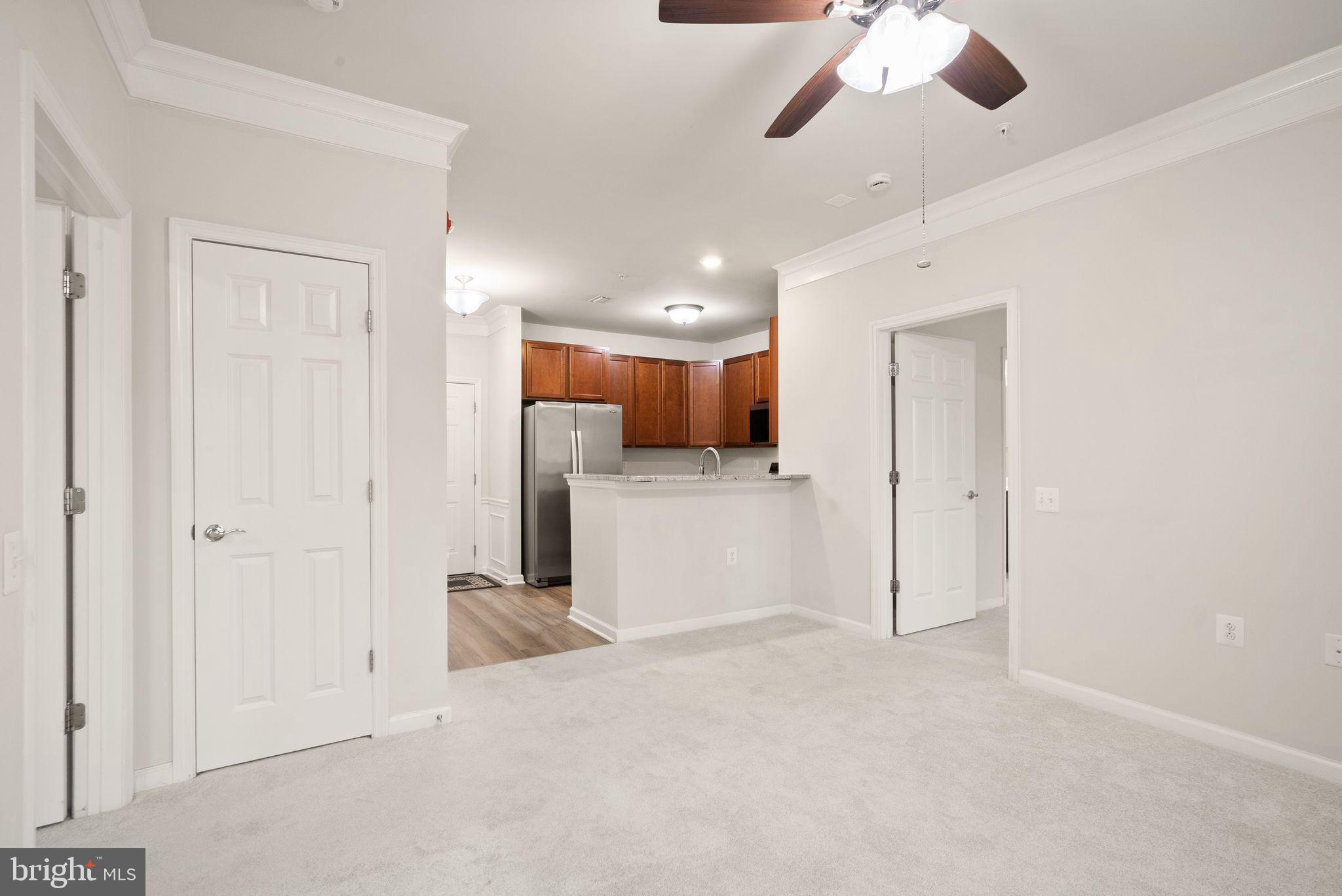 20610 Hope Spring Terrace, Unit 104 Ashburn, VA 20147 - Photo 12 of 38 Living Area and Kitchen