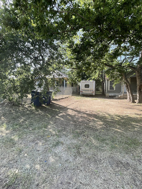 3208 East 16th Street Austin, TX 78721 - Photo 3 of 11 Mature trees shade this modest residence, providing a verdant canopy over the property's perimeter.