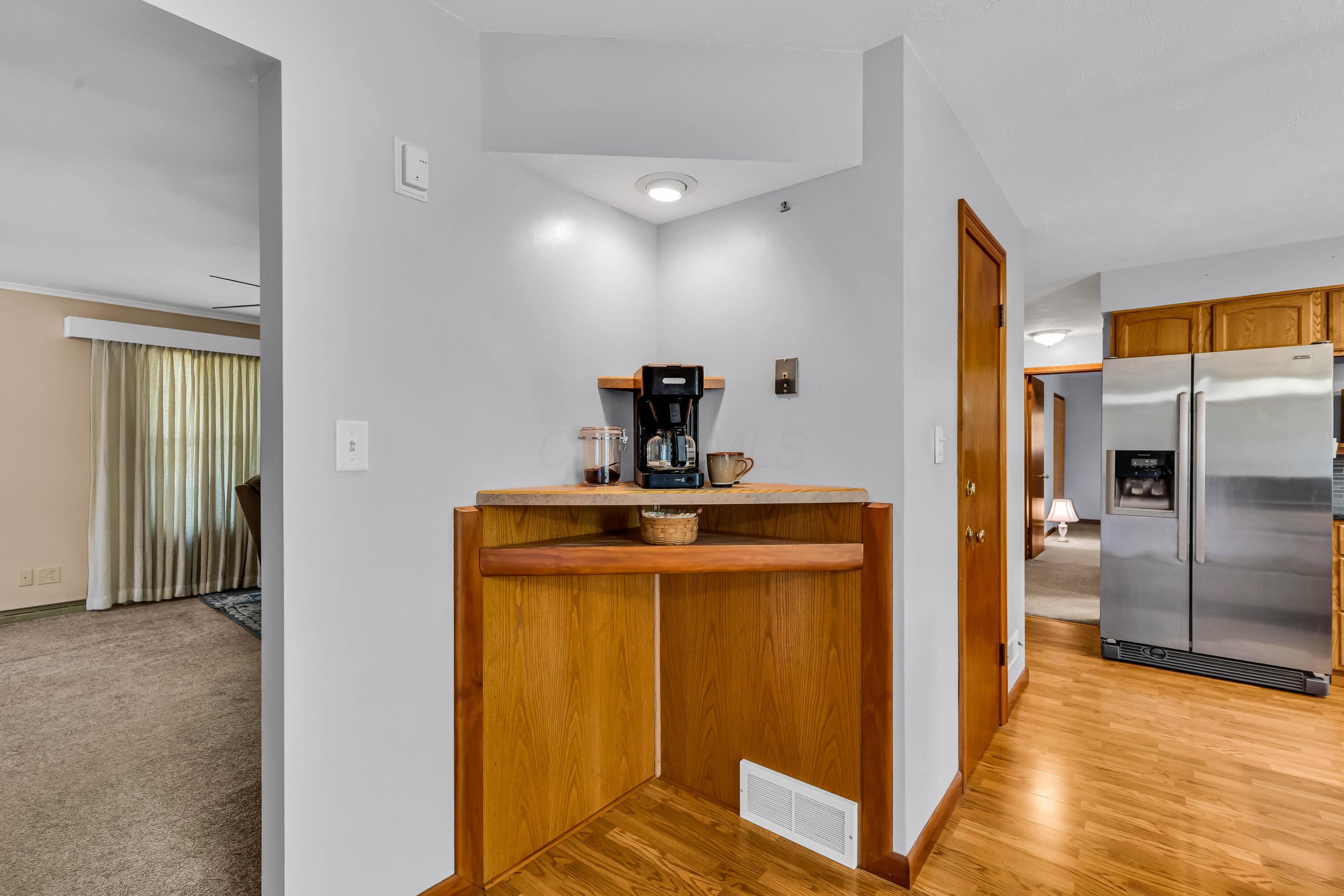 1213 East Cooke Road Columbus, OH 43224 - Photo 16 of 57 • Laminate flooring • Tan painted walls • Lighted ceiling fan • Corner wall shelf