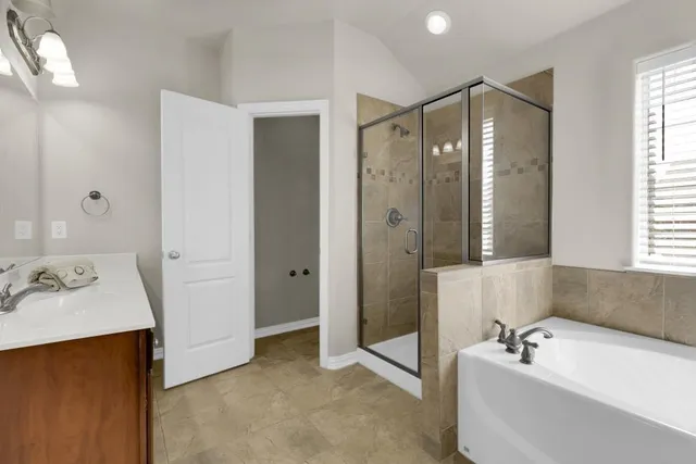 a bathroom with a tub sink and mirror