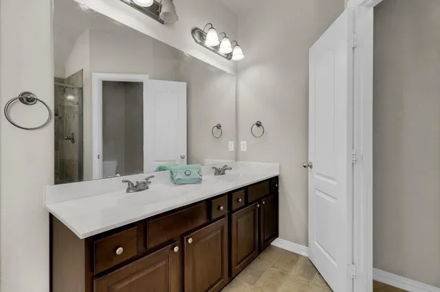 a bathroom with a sink double vanity and a mirror