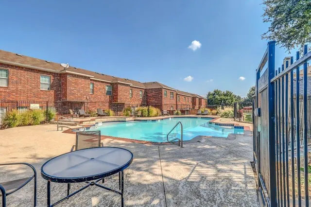 a view of a chairs and table in patio with a yard