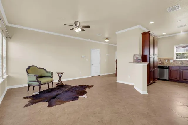 a living room with furniture and kitchen view