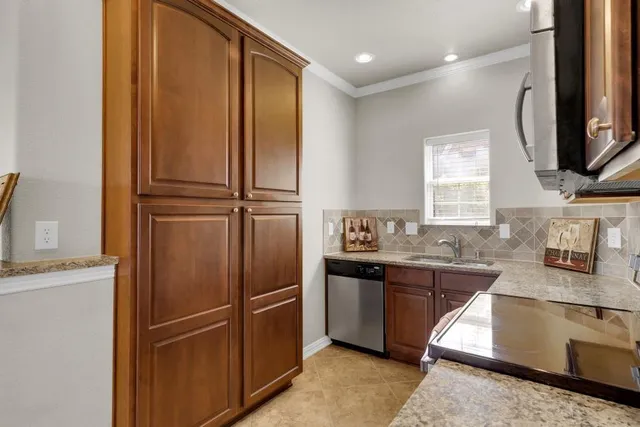 a kitchen with stainless steel appliances granite countertop a refrigerator and a sink