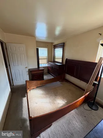 a living room with furniture and a air conditioner vent