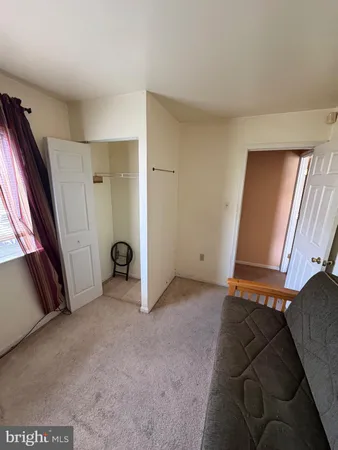 a bedroom with a bed and a chair