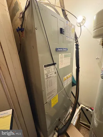 a close up of a wall with water heater and wooden floor