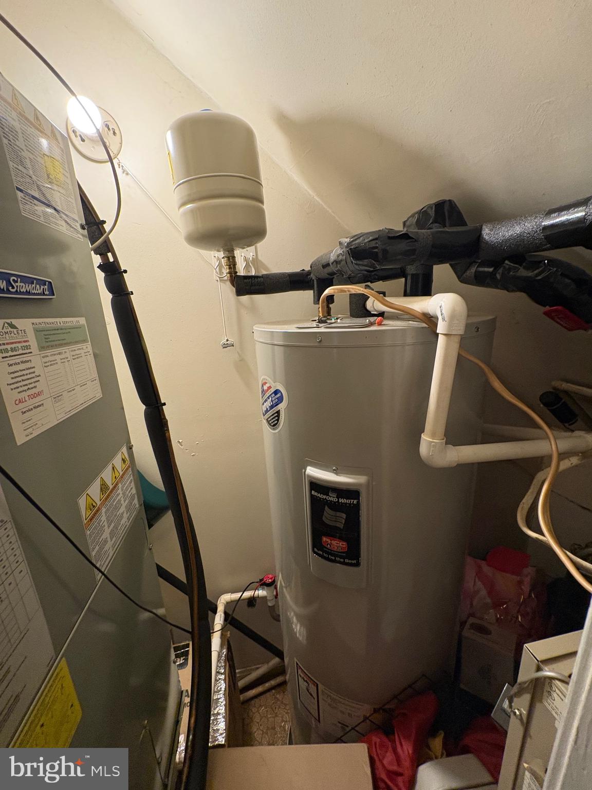 3071 Heath Cote Road Waldorf, MD 20602 - Photo 5 of 21 a close up of a wall with water heater and wooden floor