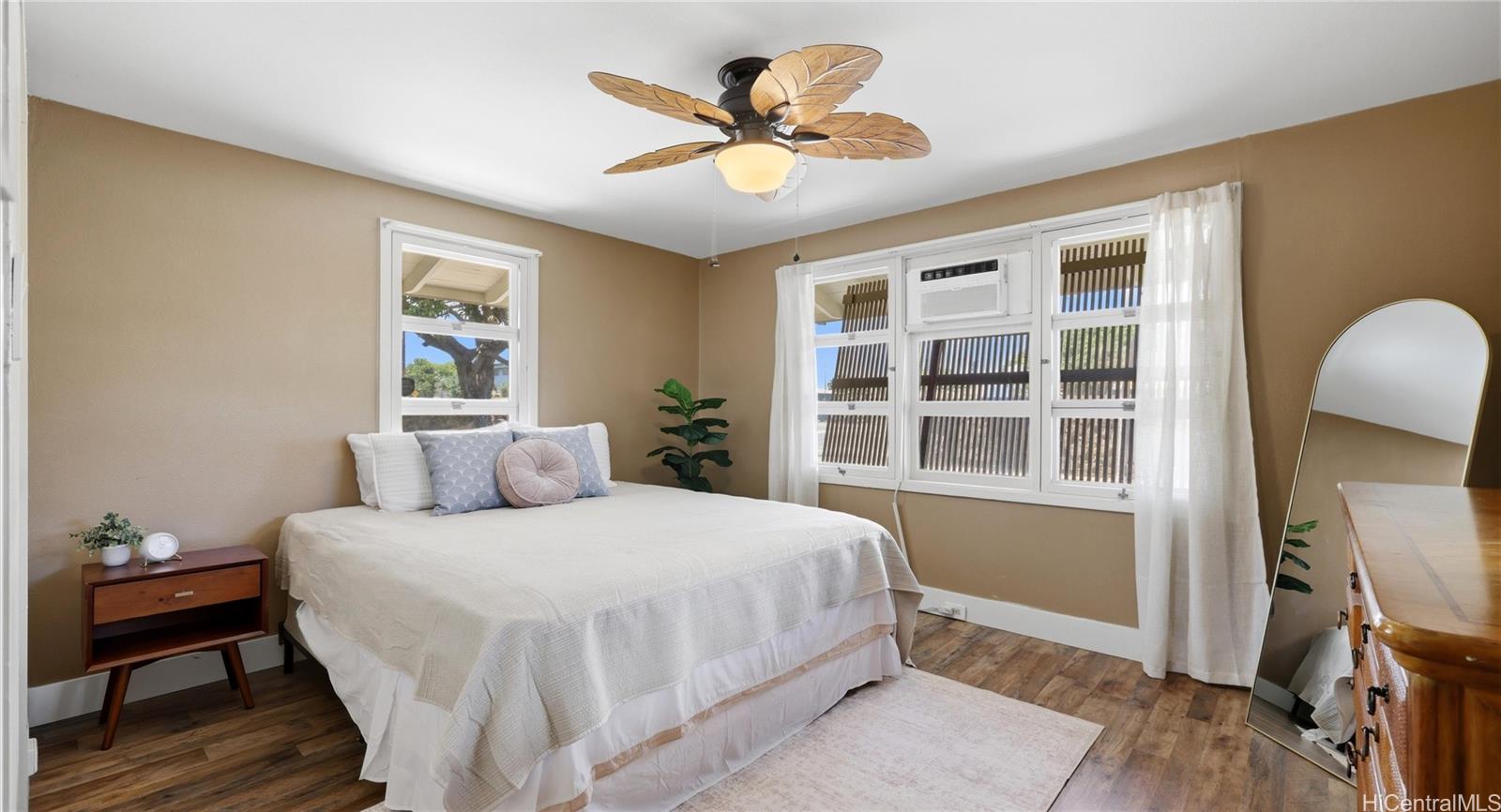 91-779 Fort Weaver Road Ewa Beach, HI 96706 - Photo 17 of 25 Main-level bedroom featuring a tropical leaf ceiling fan, window AC, and great natural light.