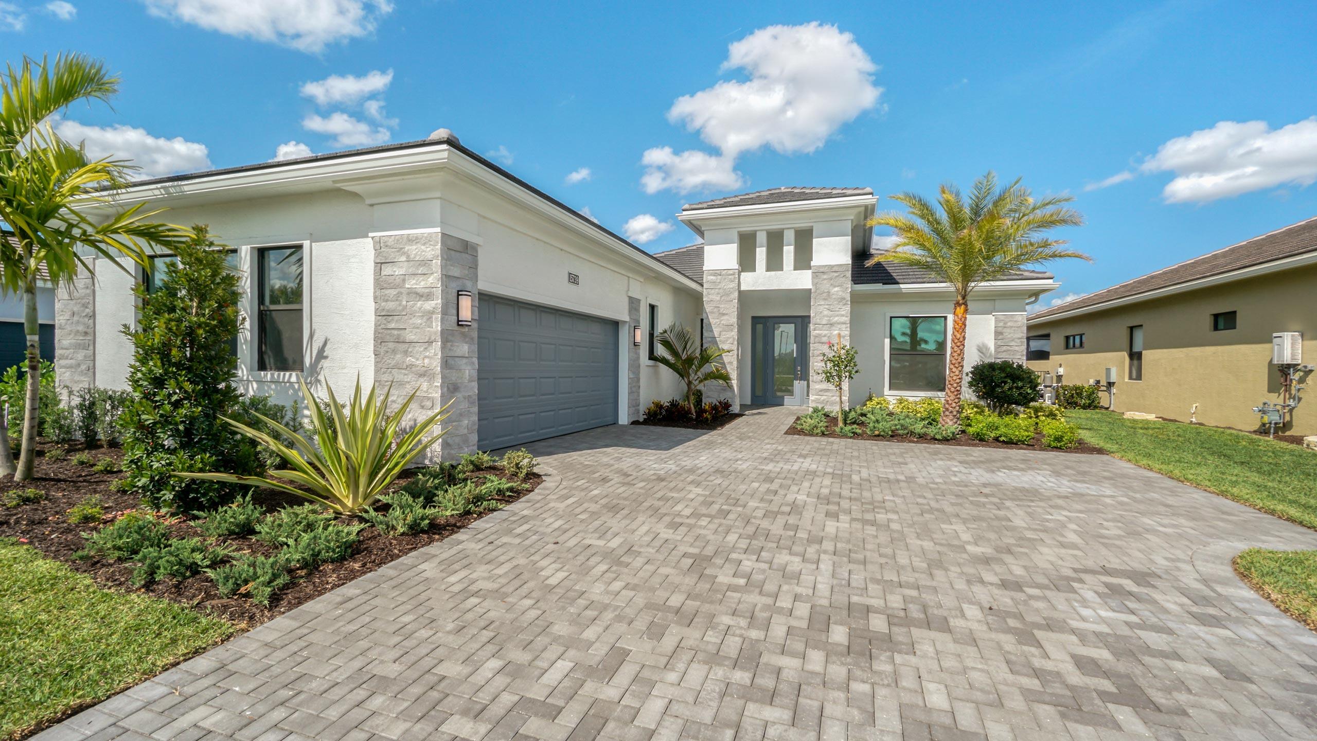 15739 Cresswind Place Westlake, FL 33470 - Photo 1 of 48 a front view of a house with a yard and potted plants