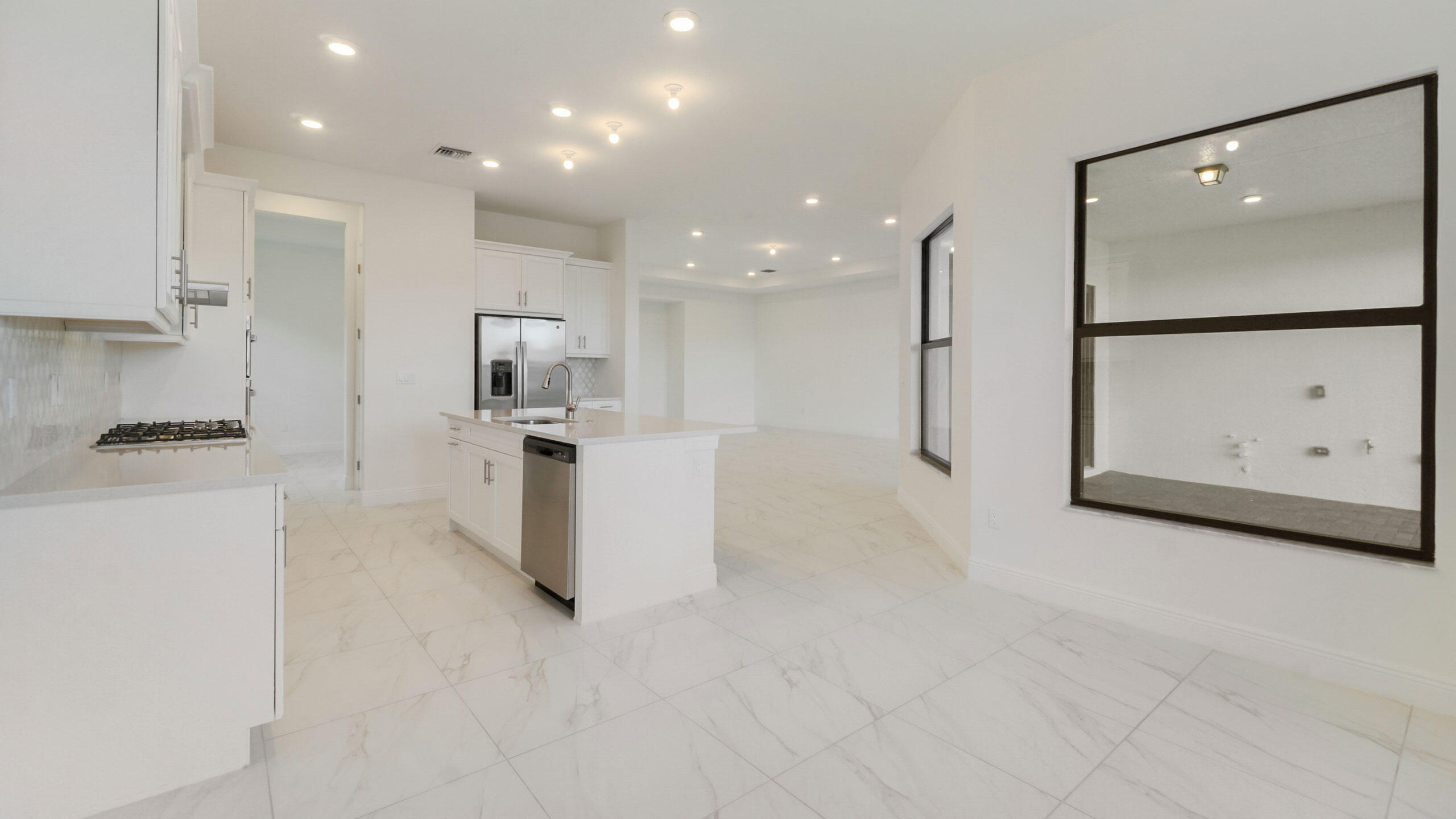 15739 Cresswind Place Westlake, FL 33470 - Photo 11 of 48 a kitchen with stainless steel appliances granite countertop a refrigerator and a stove top oven