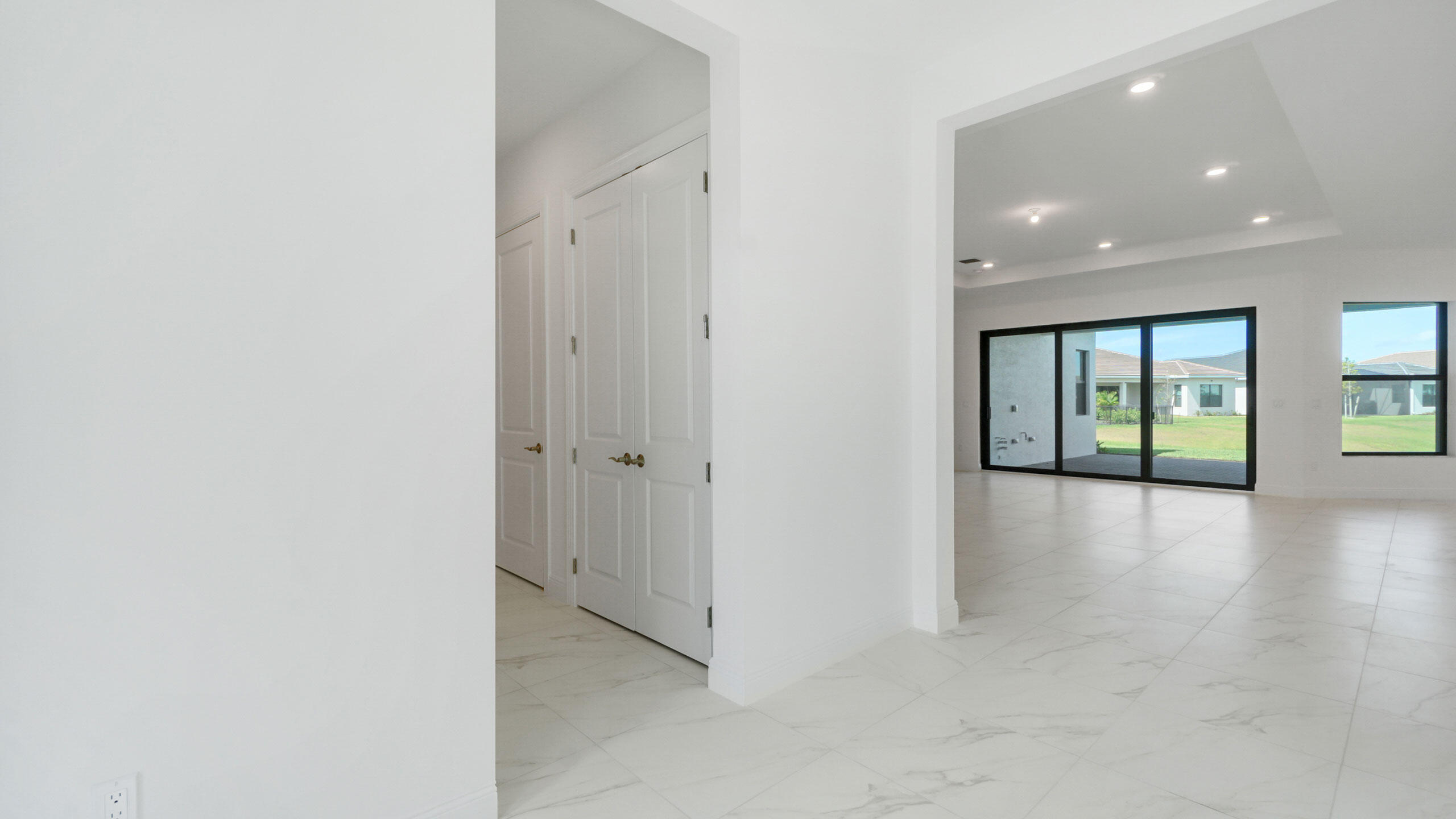 15739 Cresswind Place Westlake, FL 33470 - Photo 20 of 48 a view of an empty room with window and wooden floor