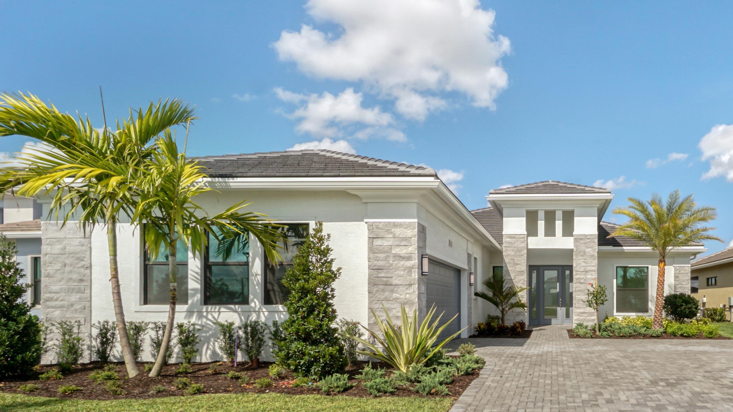 15739 Cresswind Place Westlake, FL 33470 - Photo 2 of 48 a front view of a house with a garden
