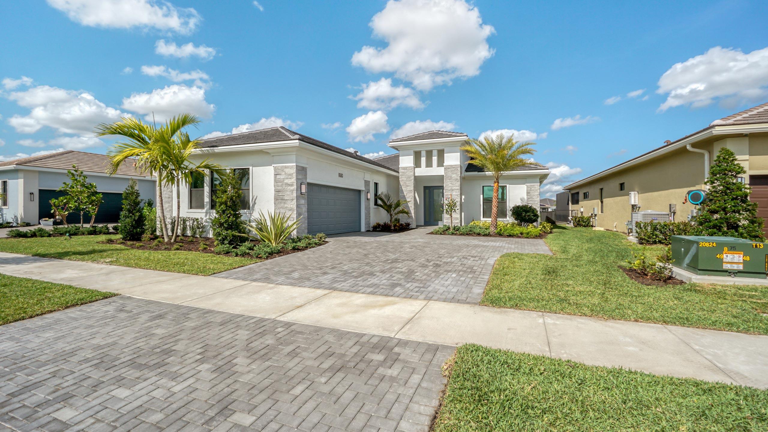 15739 Cresswind Place Westlake, FL 33470 - Photo 3 of 48 a front view of a house with garden