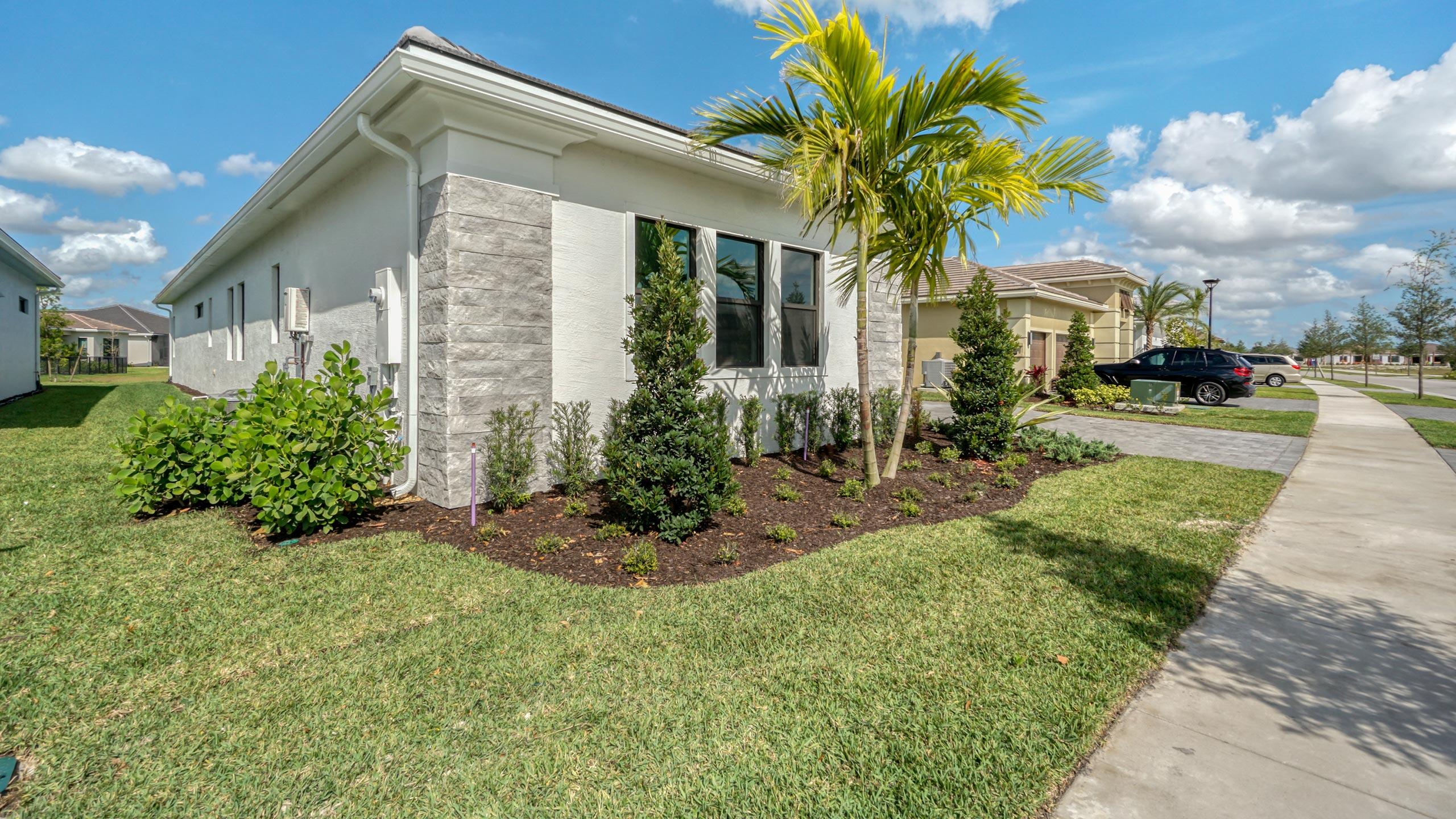 15739 Cresswind Place Westlake, FL 33470 - Photo 4 of 48 a view of a house with a yard and potted plants