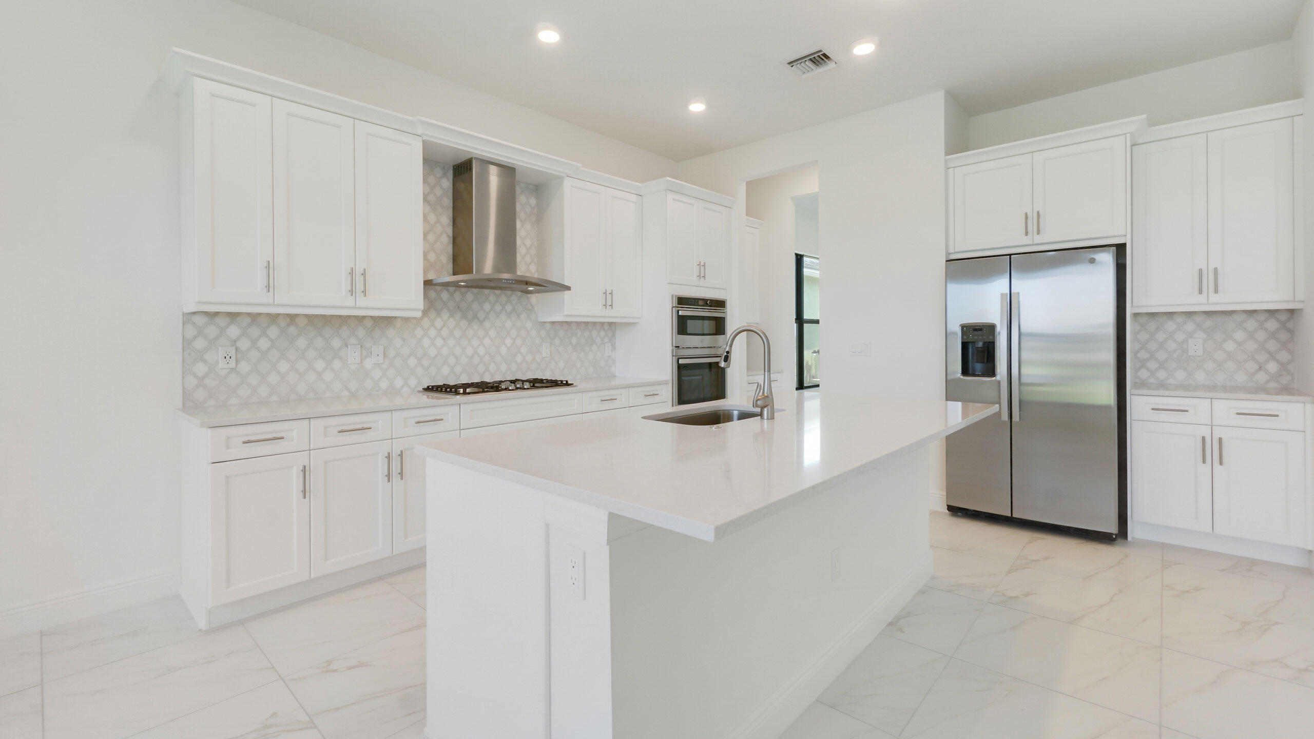 15739 Cresswind Place Westlake, FL 33470 - Photo 5 of 48 a kitchen with stainless steel appliances granite countertop a refrigerator and a stove