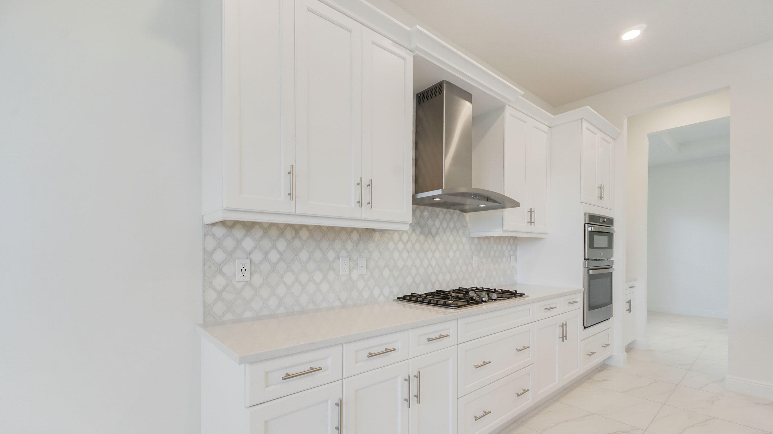 15739 Cresswind Place Westlake, FL 33470 - Photo 6 of 48 a kitchen with stainless steel appliances granite countertop a sink a stove and a refrigerator
