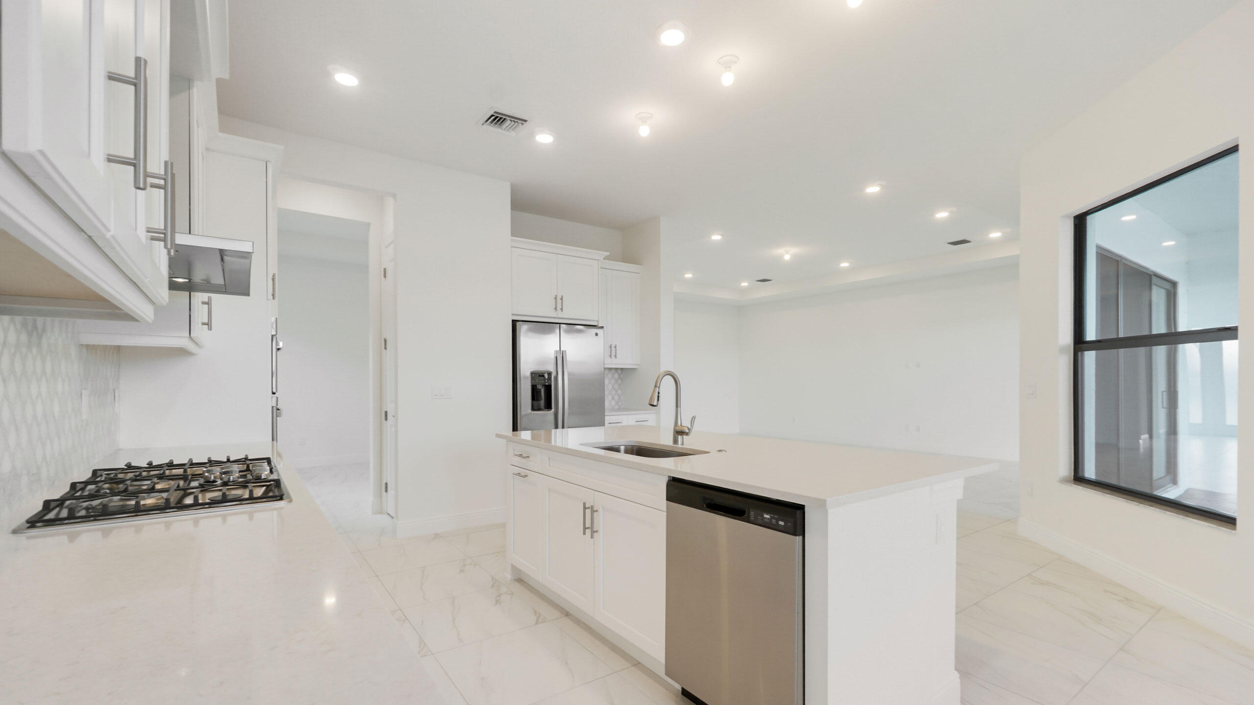 15739 Cresswind Place Westlake, FL 33470 - Photo 8 of 48 a kitchen with a sink stainless steel appliances and cabinets