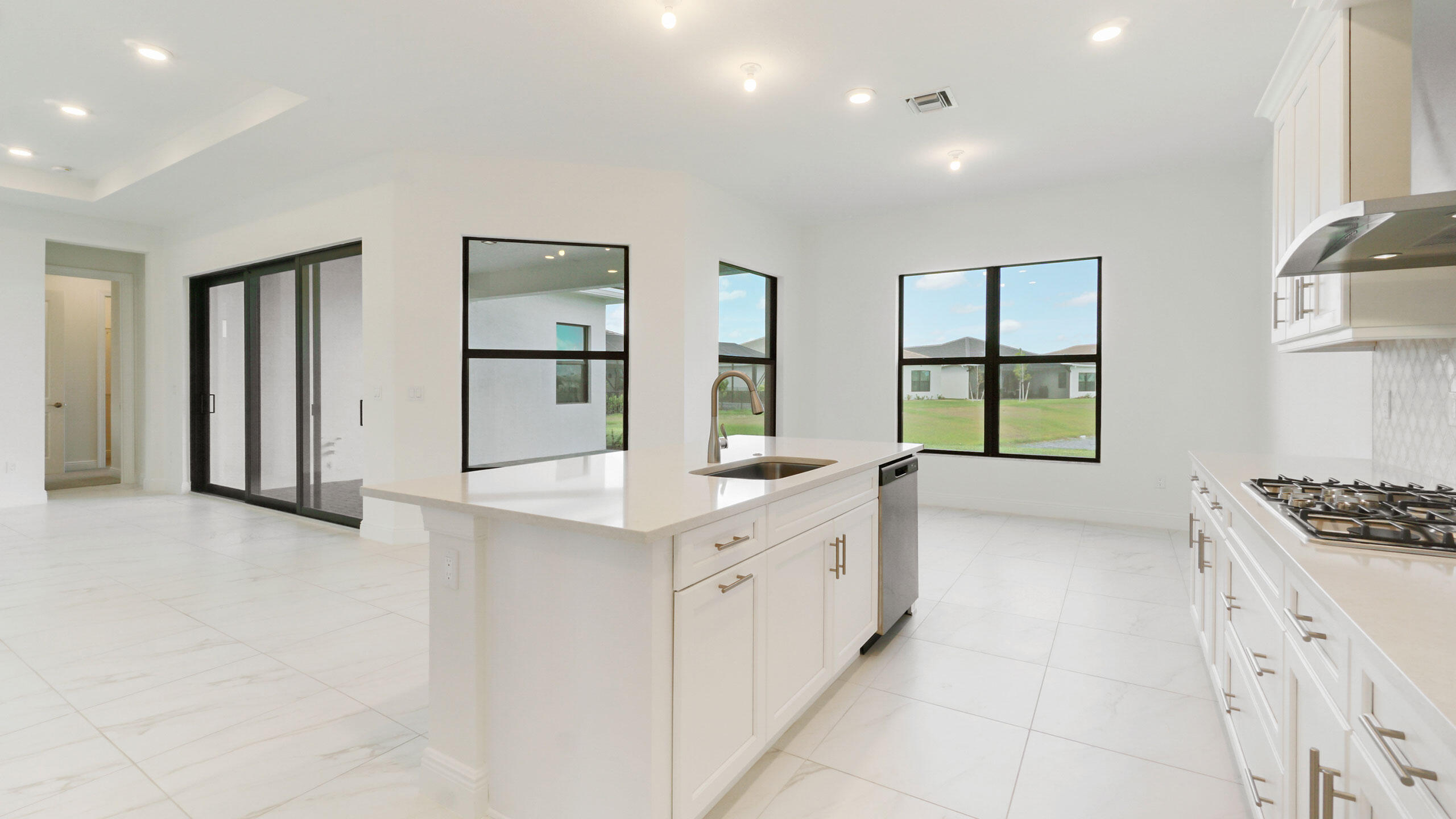 15739 Cresswind Place Westlake, FL 33470 - Photo 10 of 48 a kitchen with white cabinets and sink