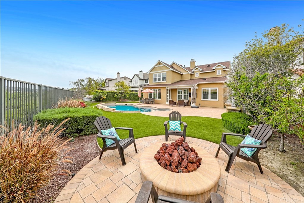 18 Abyssinian Way Ladera Ranch, CA 92694 - Photo 1 of 1 Oversized yard (8100+ sqft) with fire pit, built-in kitchen, saltwater pool and spa, dining area, conversation area, lawn and mature citrus trees. No better place to be for the 4th of July.