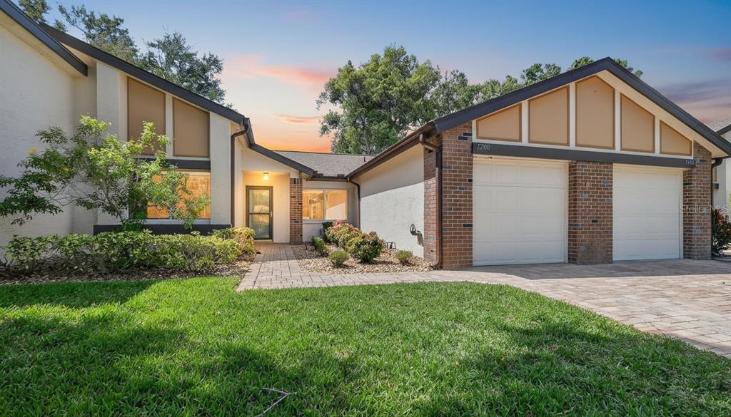 7280 Scotland Circle Weeki Wachee, FL 34613 - Photo 1 of 42 a front view of a house with a yard and porch