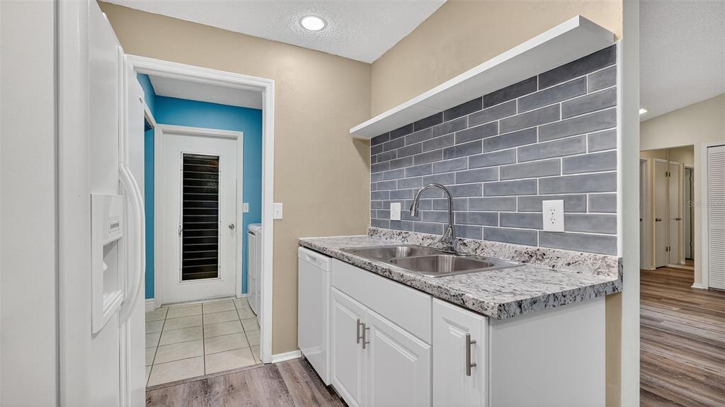 7280 Scotland Circle Weeki Wachee, FL 34613 - Photo 15 of 42 a kitchen with a granite countertop sink and cabinets