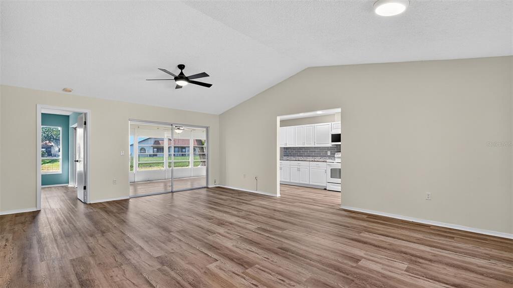 7280 Scotland Circle Weeki Wachee, FL 34613 - Photo 16 of 42 wooden floor in an empty room with a window