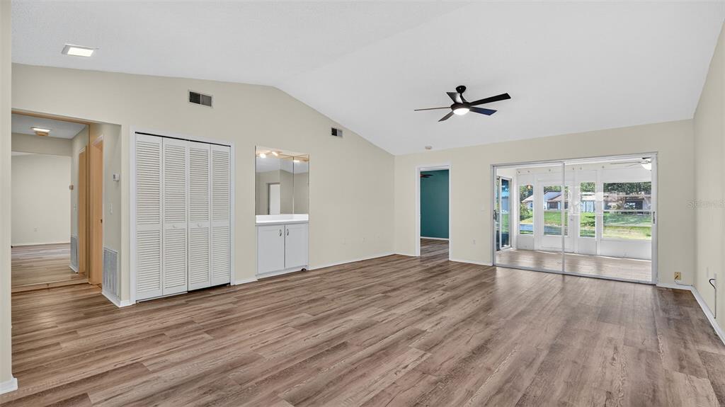 7280 Scotland Circle Weeki Wachee, FL 34613 - Photo 18 of 42 a view of empty room with wooden floor and fan