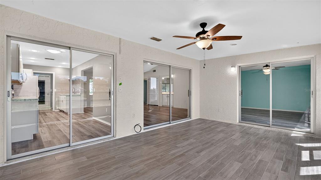 7280 Scotland Circle Weeki Wachee, FL 34613 - Photo 20 of 42 a view of empty room with wooden floor and fan