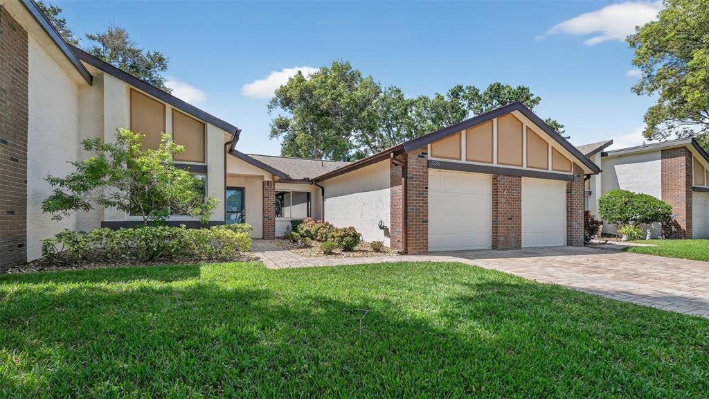 7280 Scotland Circle Weeki Wachee, FL 34613 - Photo 2 of 42 a view of a house with a yard and sitting area