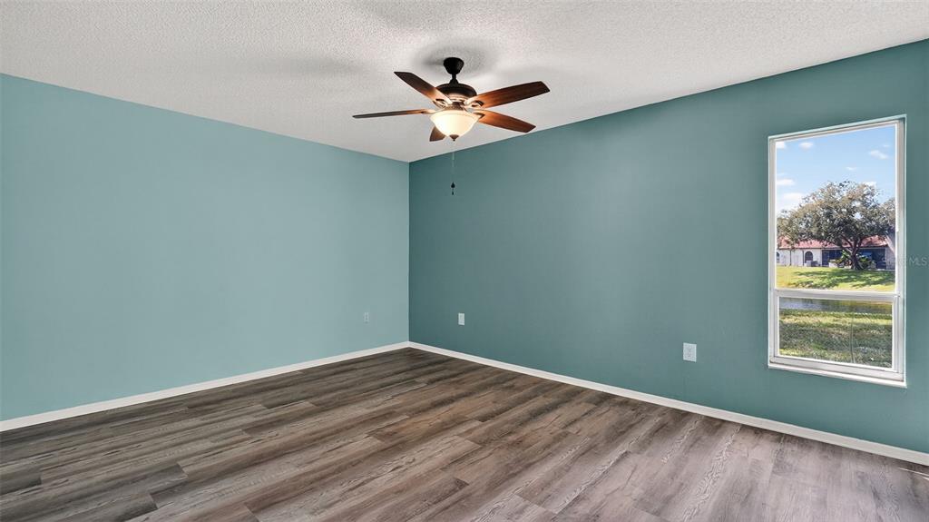 7280 Scotland Circle Weeki Wachee, FL 34613 - Photo 24 of 42 wooden floor in an empty room with a window