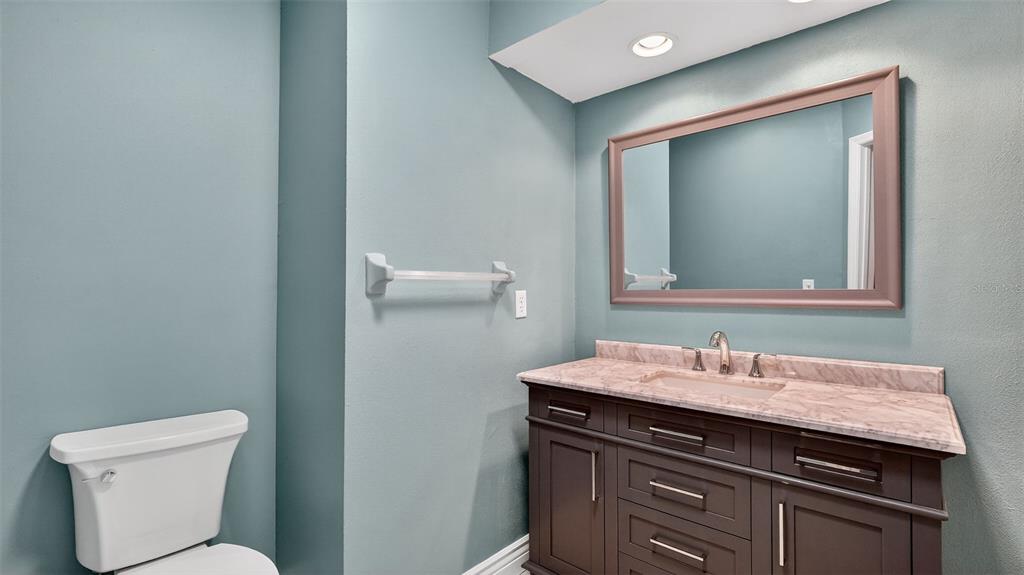 7280 Scotland Circle Weeki Wachee, FL 34613 - Photo 26 of 42 a bathroom with a toilet sink and mirror