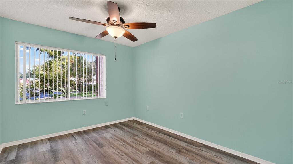 7280 Scotland Circle Weeki Wachee, FL 34613 - Photo 29 of 42 a view of room with window ceiling fan and hardwood floor