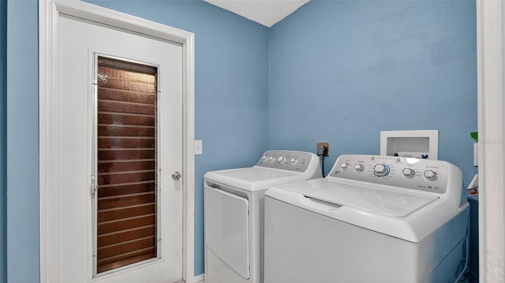 7280 Scotland Circle Weeki Wachee, FL 34613 - Photo 31 of 42 a utility room with dryer and washer