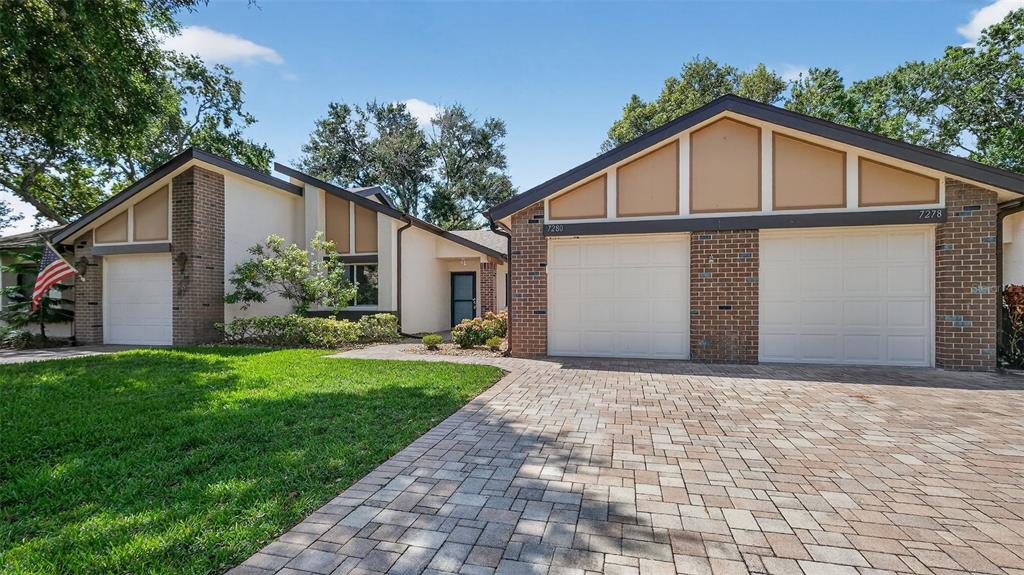 7280 Scotland Circle Weeki Wachee, FL 34613 - Photo 4 of 42 a front view of a house with garden