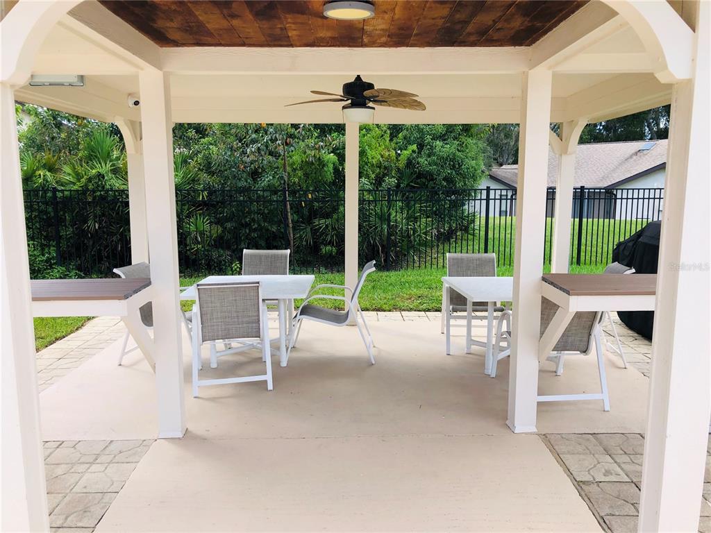 7280 Scotland Circle Weeki Wachee, FL 34613 - Photo 41 of 42 a view of a patio with a table chairs and a backyard