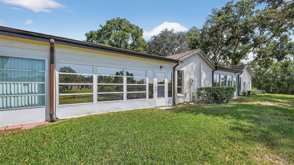 7280 Scotland Circle Weeki Wachee, FL 34613 - Photo 8 of 42 a view of a house with a yard and sitting area
