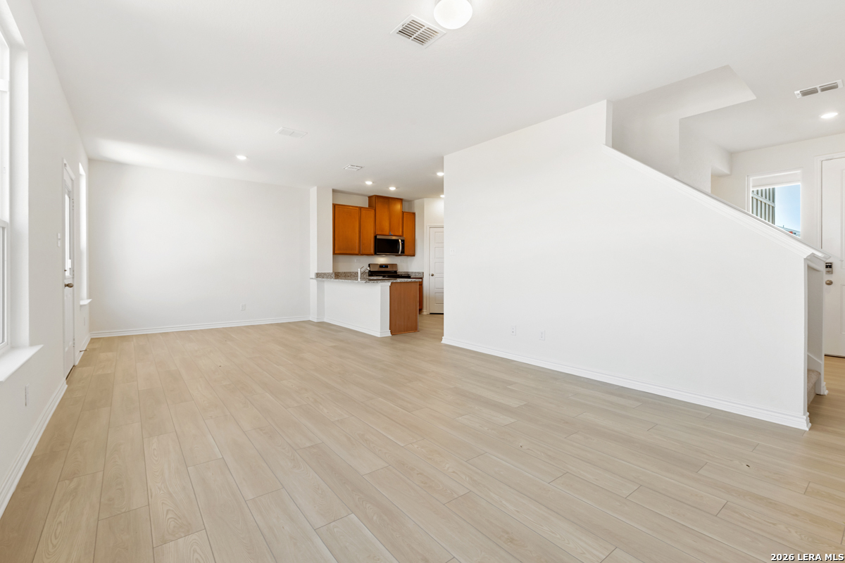 10045 Jagger Avenue Converse, TX 78109 - Photo 10 of 28 a view of empty room with wooden floor and a window