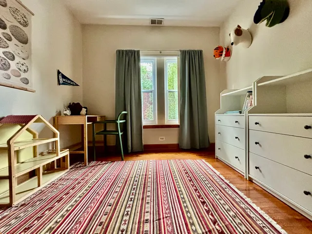 a kitchen with stainless steel appliances granite countertop a refrigerator a sink a stove and blue cabinets