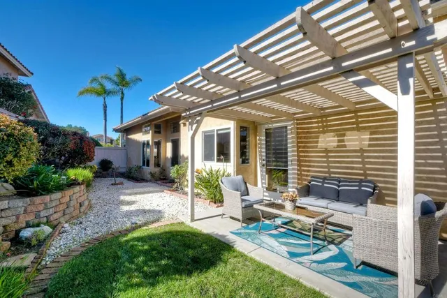 a house view with a sitting space and garden