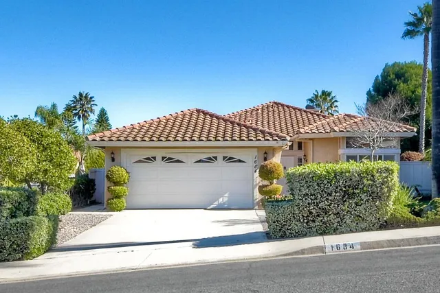 a view of a sign board with a big yard and large trees