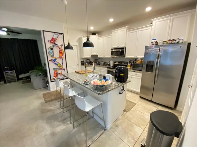 a backyard of a house with table and chairs