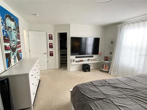 a room with furniture pool table and window