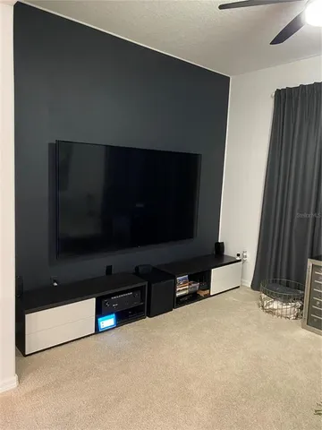 a view of a room with furniture and a window