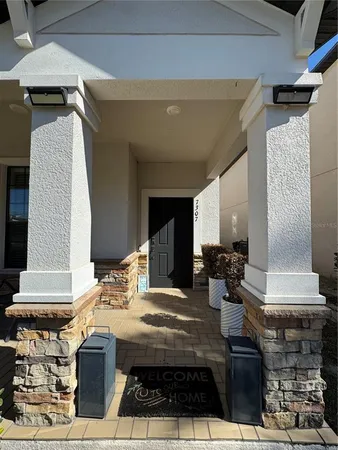 a living room with furniture a air conditioner and a window